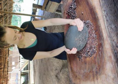 woman-crushing-roasted-cocao-with-stone